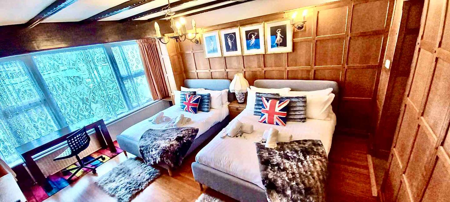 Open-plan living and dining area with solid oak table, sofas and 55-inch smart TV
