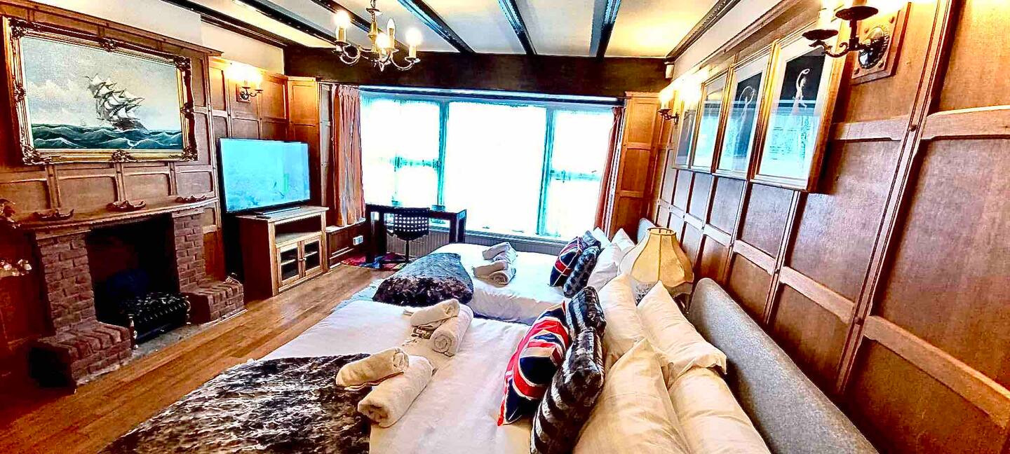 Master bedroom at Amara House with two double beds and a solid oak work desk