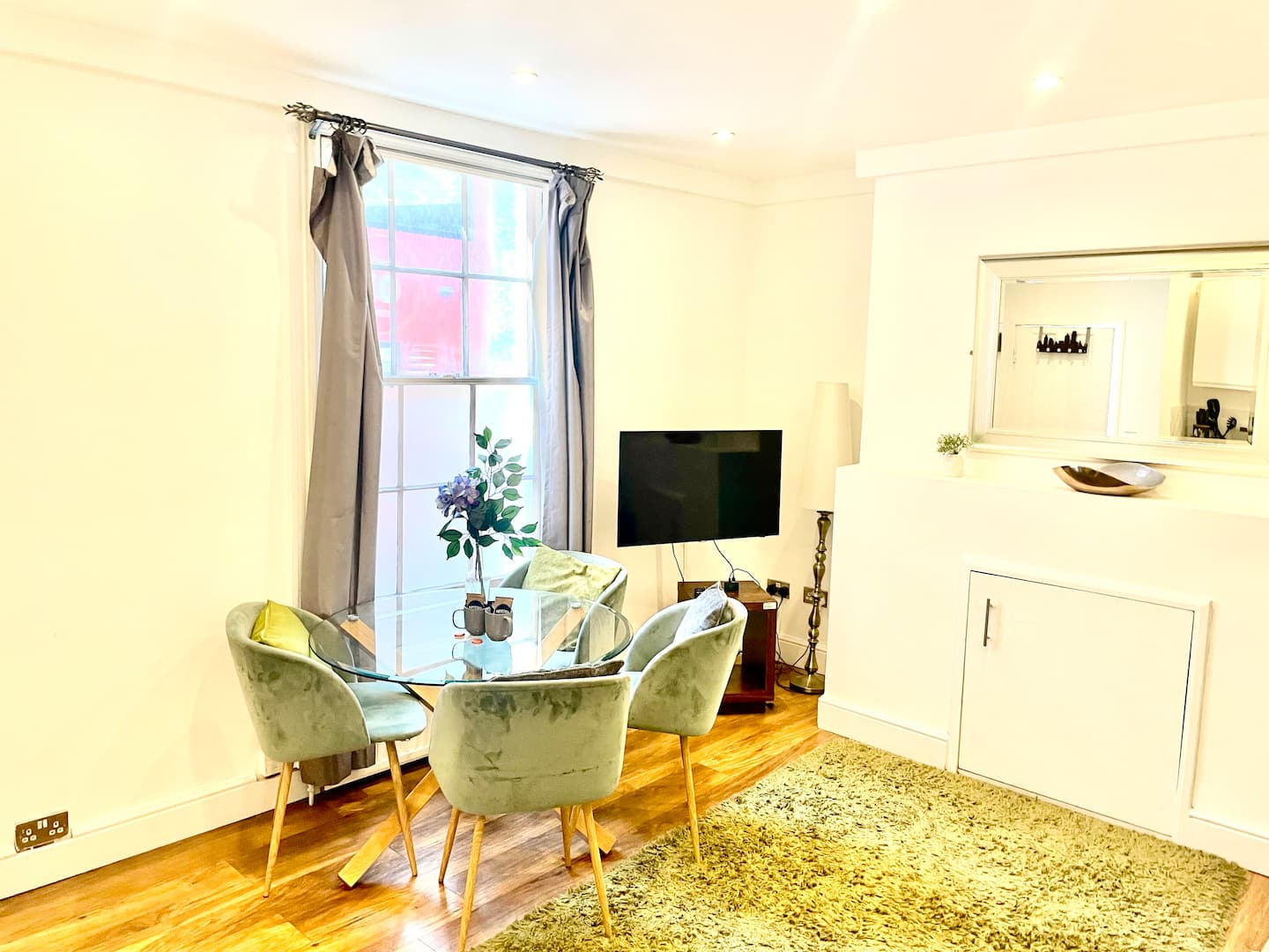 Living area seating with sofa and soft furnishings in the Cambridge apartment