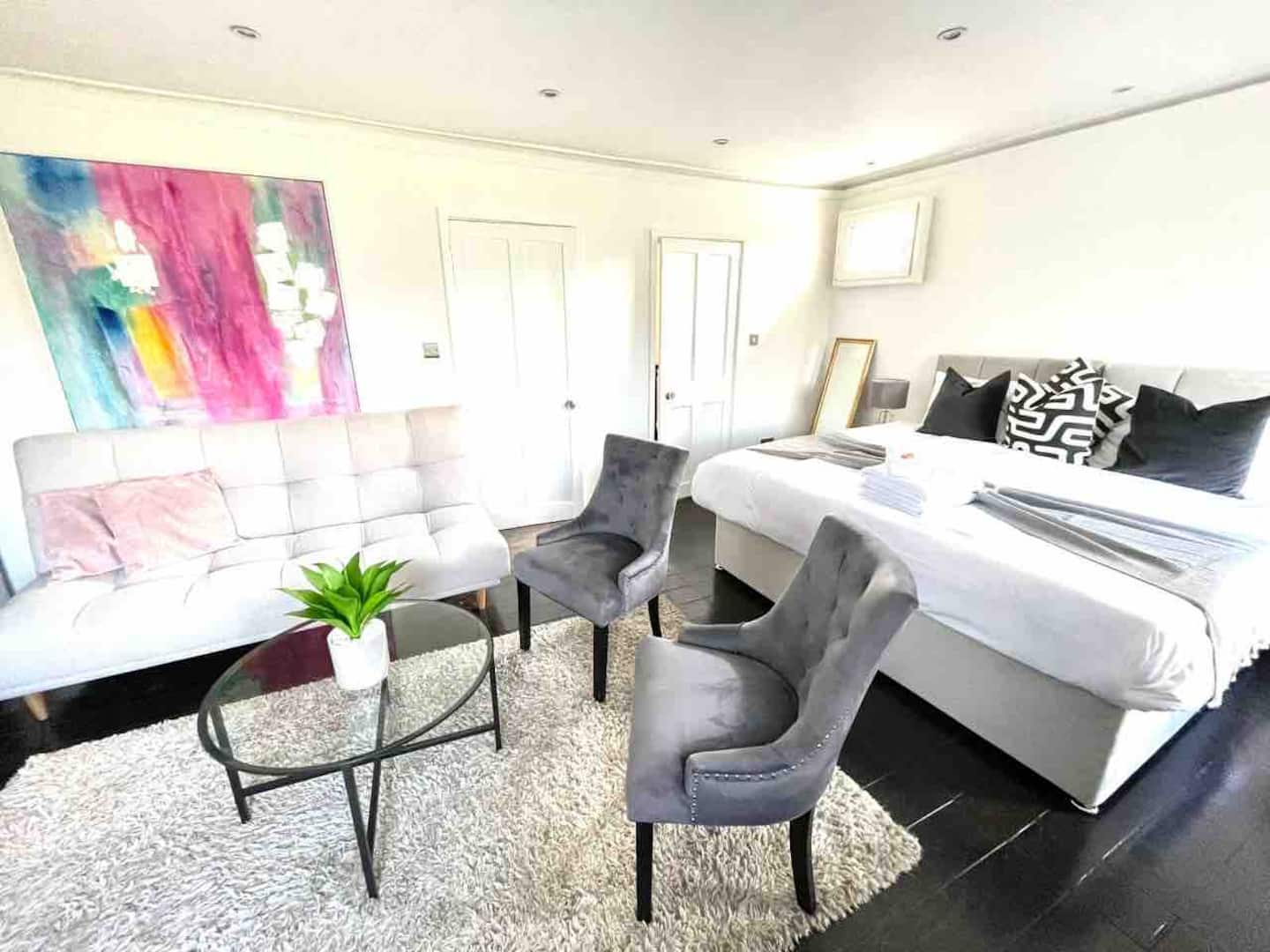 Bright studio-style interior with king bed and large windows