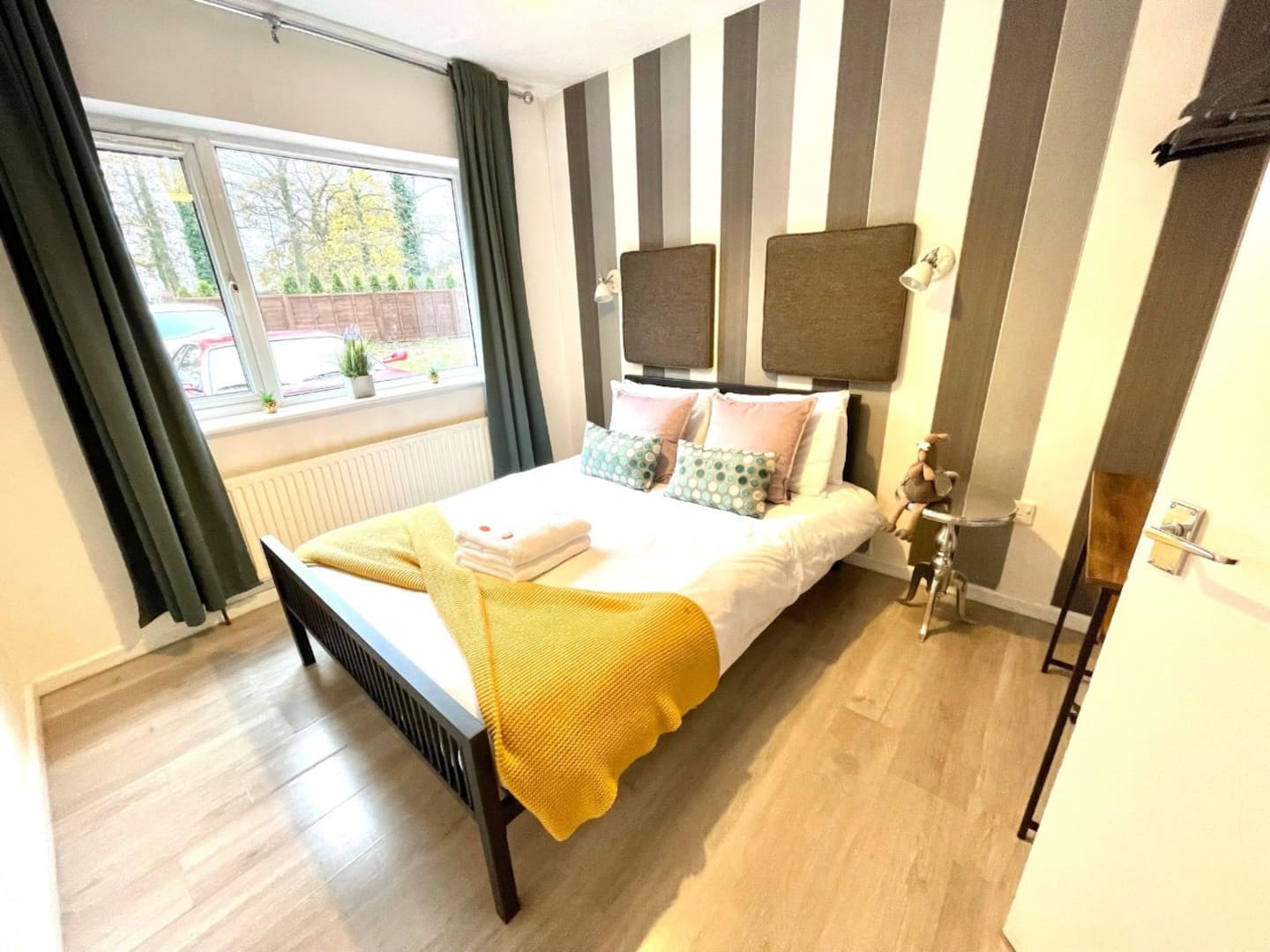 Living area of the serene one-bedroom apartment in south Cambridge with sofas and large television