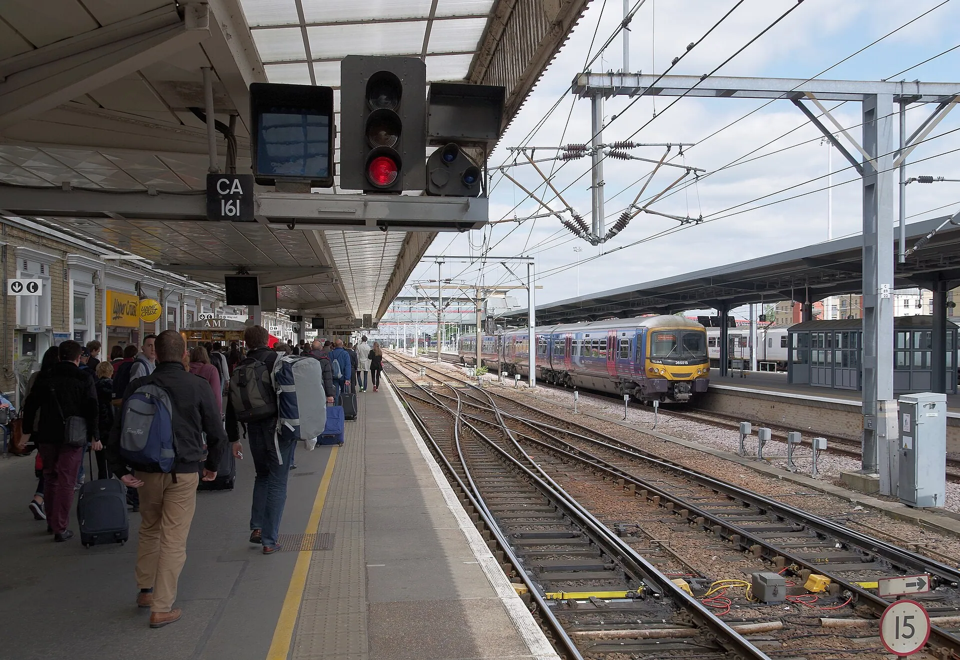 A train at the main platform of Cambridge railway station, England, with passengers walking alongside