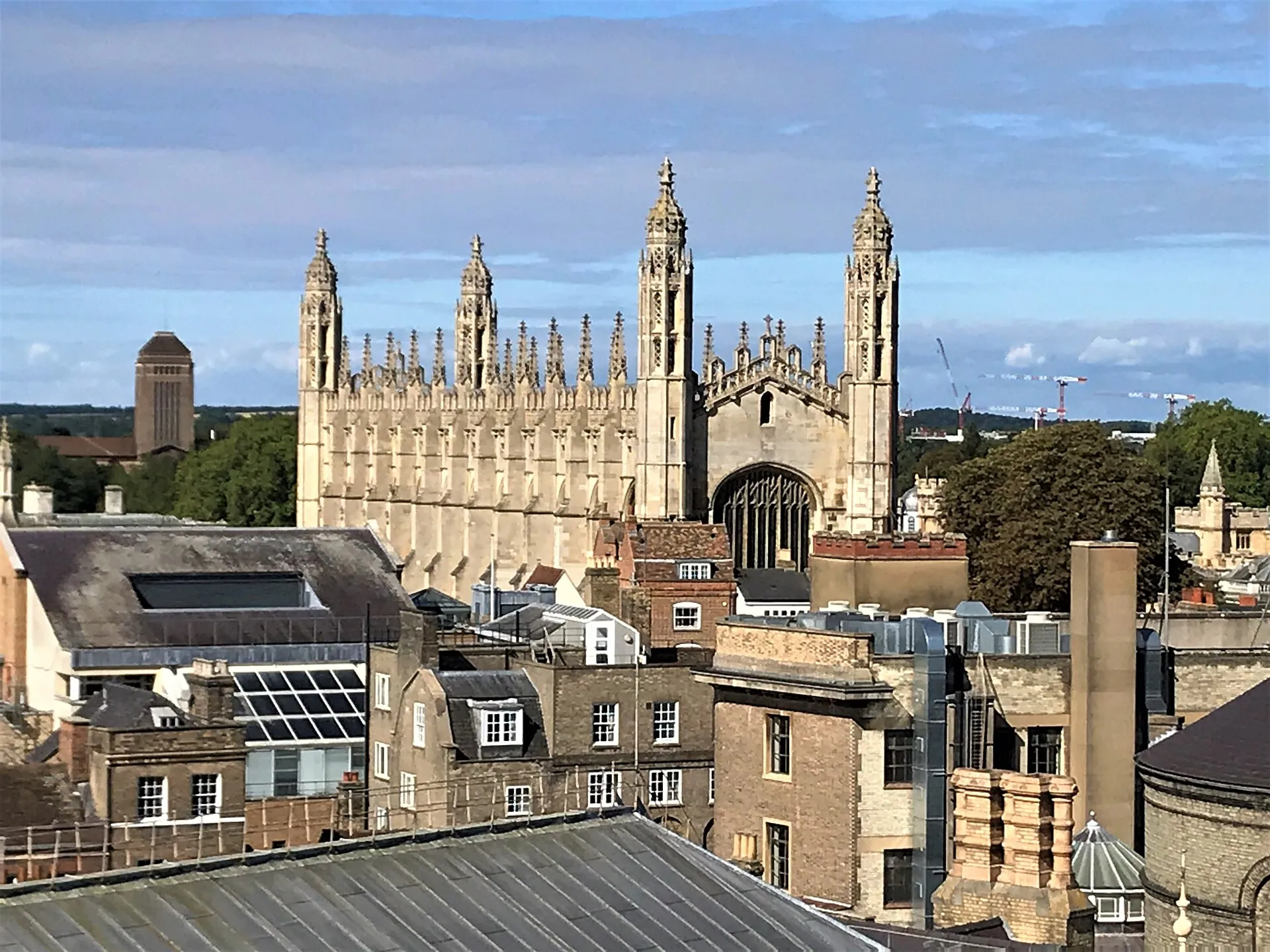The exterior of King's College Chapel, Cambridge, rising above surrounding city rooftops