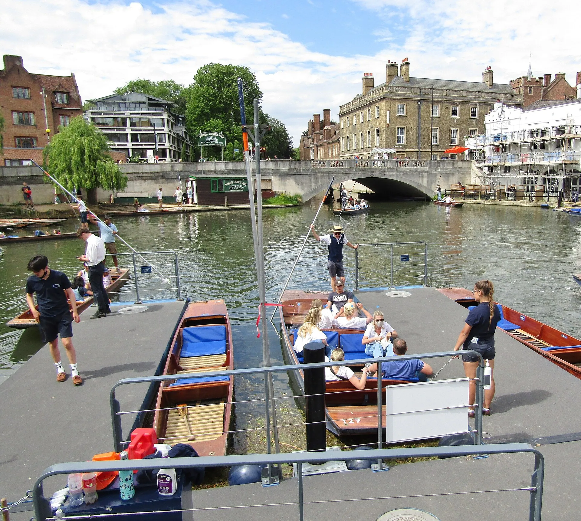 Punts being poled along the River Cam beside a bridge in central Cambridge, England